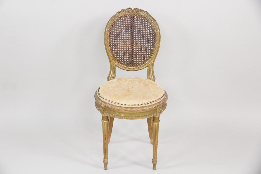 Neoclassical Gilt Wood & Caned Medallion Chair: Neoclassical Louis XVI Gilt Wood & Caned Medallion Chair. This side chair features a round upholstered seat and oval cane backrest. The frame is crafted from carved giltwood and is supported by
