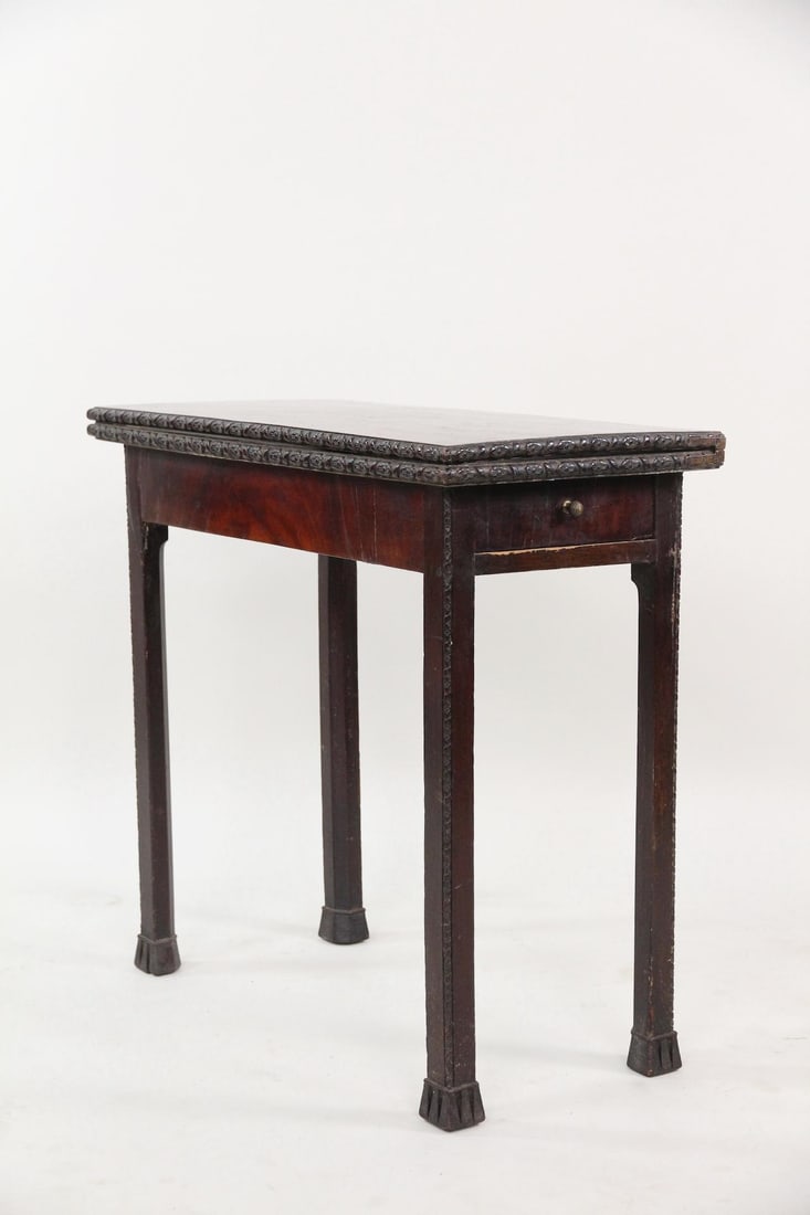 Carved Floral Edge Mahogany Game Table: Carved Floral Edge Mahogany Game Table. This gate leg folding tea or game table that opens to a full square. The edge is carved with a floral pattern. Opens to 31 in square. Dimensions are 30 in h x