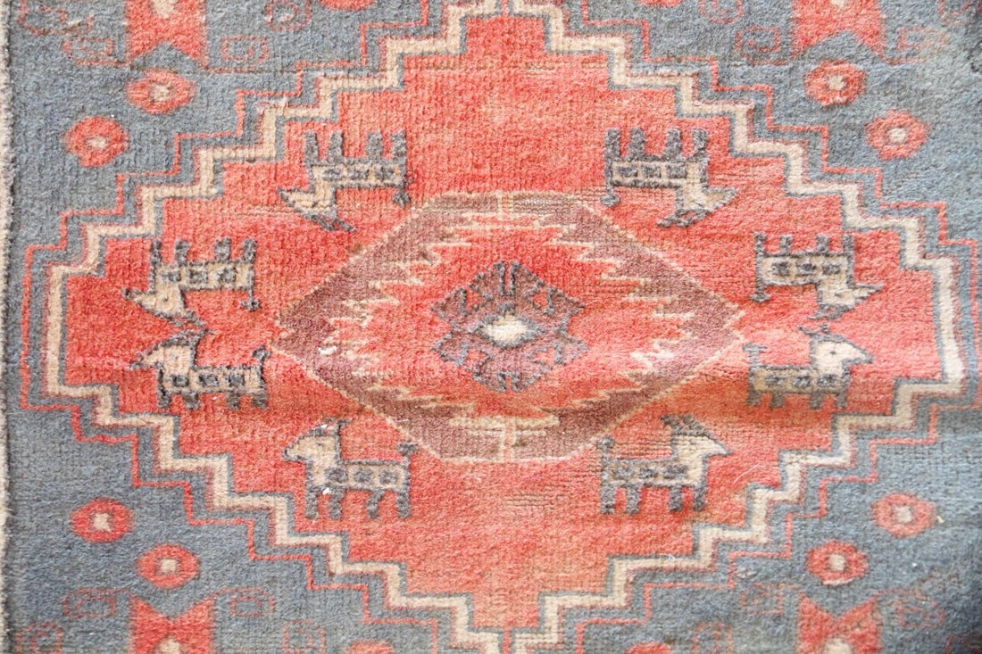 Turkish Wool Rug, Geometric & Animal Motifs: Turkish Oushak Wool Rug, Geometric & Animal Motifs. A handwoven rug with three prominent red diamond medallions along with tribal cross & animal motifs. Wool on cotton. Dimensions are 41.5 in l x 85