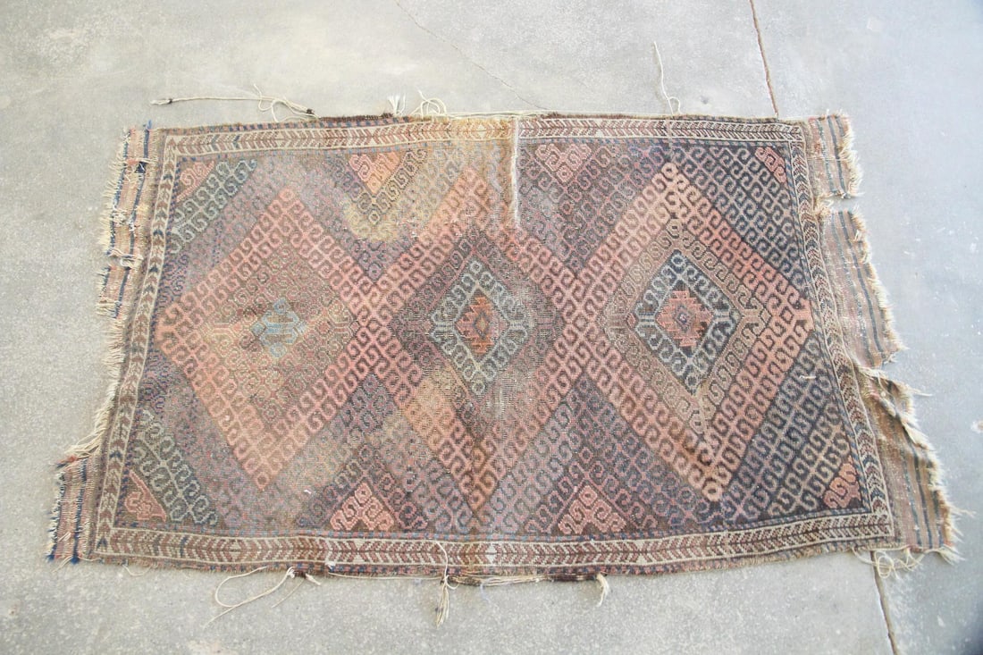 Caucasian Kilim Wool Rug, Ram's Horn Motif: Caucasian Kilim Wool Rug, Ram's Horn Motif. A handwoven rug with "ram's horn" motifs in pink, browns, and blues. An older piece, heavily worn. Dimensions are 37 in l x 61 in w. Condition is fair,