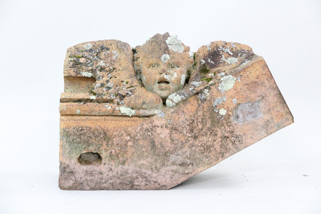 Architectural Terracotta Winged Cherub Face Keystone Building Fragment: Architectural Terracotta Cherub Face Keystone Building Fragment. Probably a keystone from a building, very ornate made of reddish clay like sewer tile or terracotta. Nice patina! Dimensions are 18 in