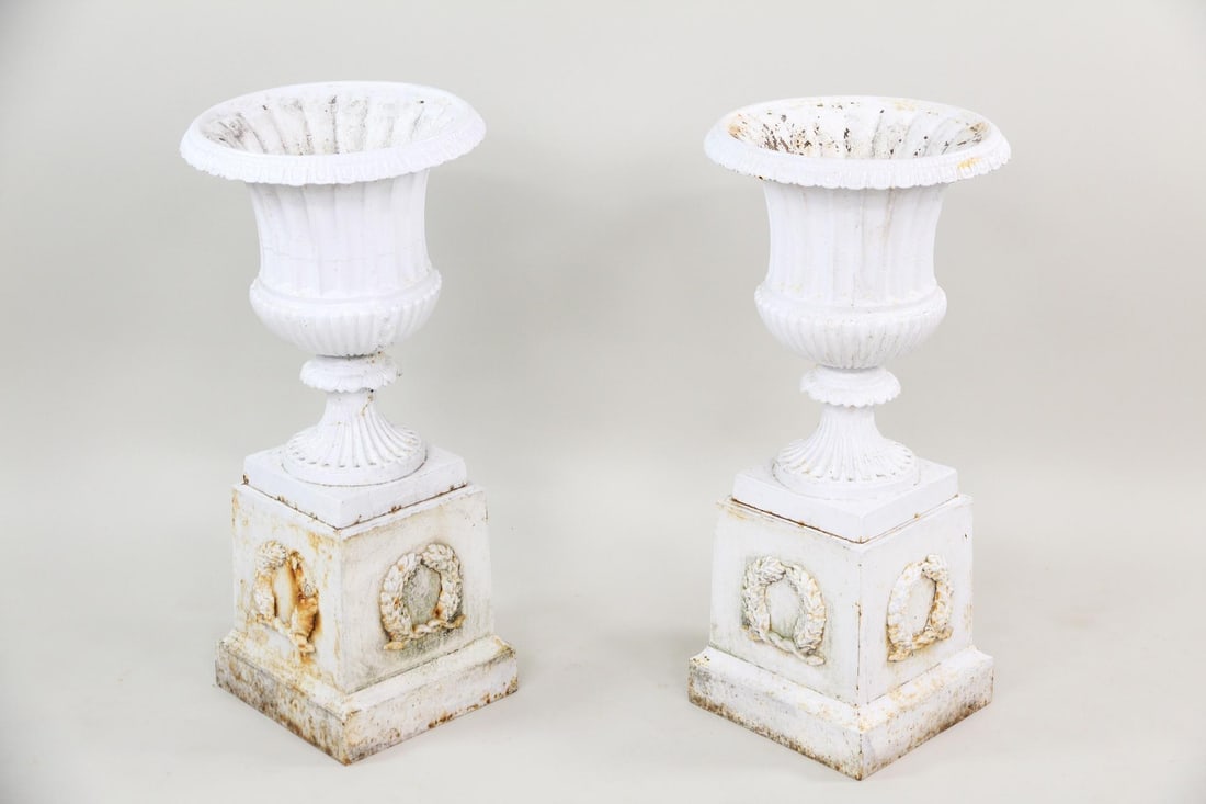 Pair of White Cast Iron Planter Urns on Pedestals: Pair of White Cast Iron Planter Urns on Pedestals. Nice matching pair of urns in white paint. Dimensions are 31 in h x 14.5 in w x 14.5 in d. Condition is good, some paint loss. Please call or email f