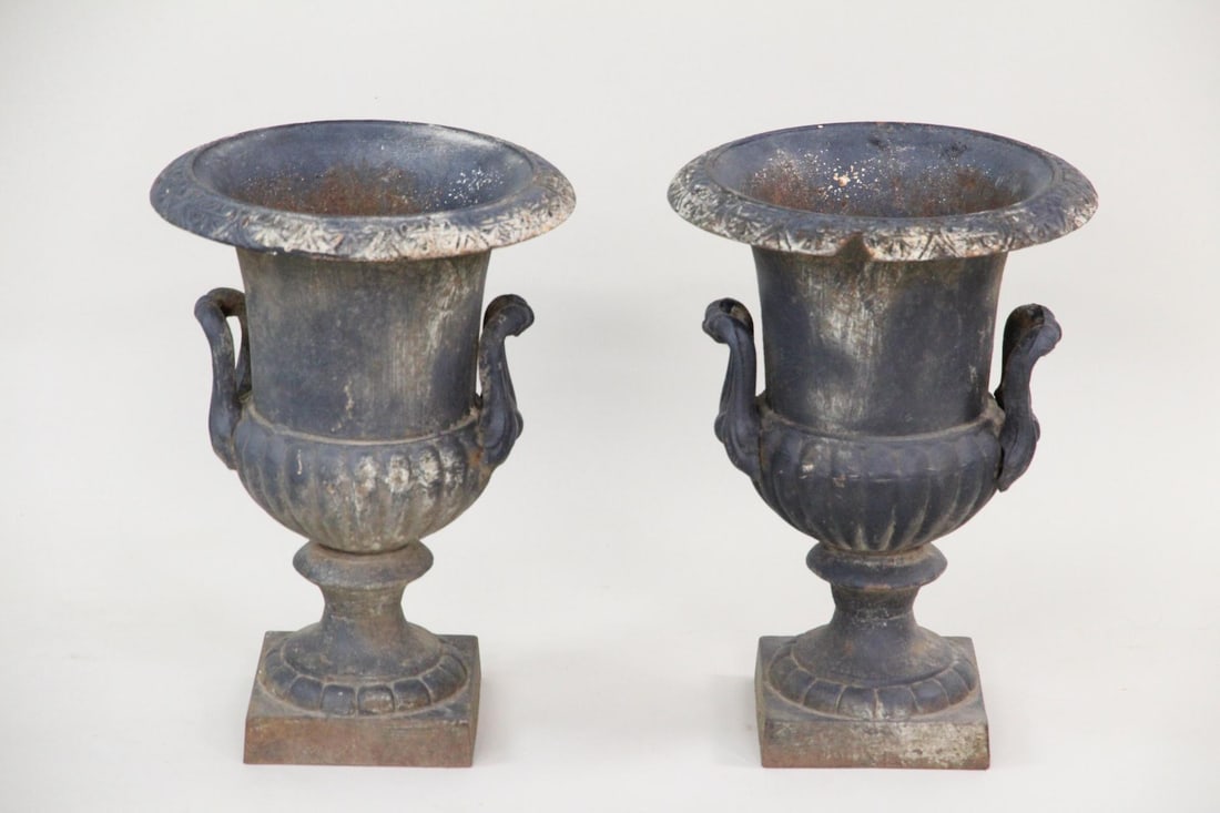 Pair of Small Black Cast Iron Planter Urns: Pair of Small Black Cast Iron Planter Urns. Nice matching pair of urns in black paint. Dimensions are 17.25 in h x 12.25 in w x 12.25 in d. Condition is good, some paint loss, one has minor chip. Plea