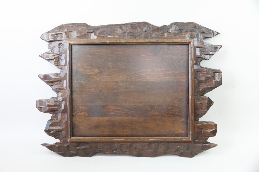 Brutalist Carved Wood Frame: Brutalist Rustic Carved Wood Frame. Large picture or mirror frame carved from wood in a brutalist style. Dimensions are 23 in h x 31 in w x 2 in d. Condition is good with a few small chips. Please cal