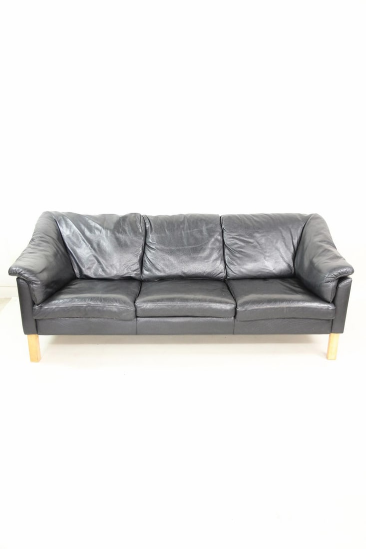 H.J. Mobler 3-Seater Sofa, Black Leather, 1 of 2: H.J. Mobler Danish Modern 3-Seater Sofa, Black Leather. A classic three-seater design upholstered in black leather and supported by light colored wooden legs. Dimensions are 29 in h x 74.5 in w x 32 i