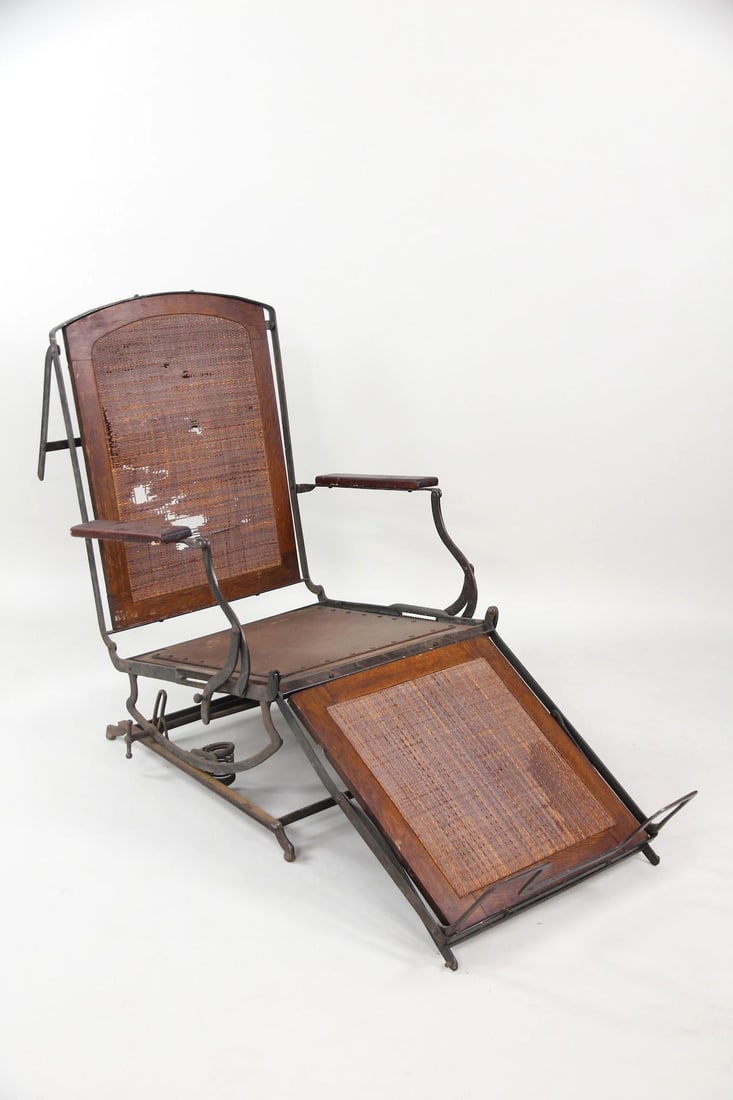 Japanned Copper Flashing Campaign Chair, Project: Japanned Campaign Project Chair, Iron & Caning. A campaign chair with a Japanned iron frame and caned seat, back, and footrest. It has an adjustable, fold-up design. Dimensions are 27.5 in h x 36.5 in
