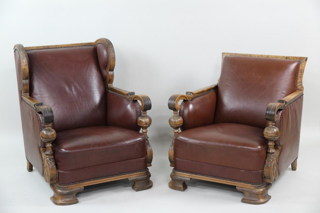 Art Nouveau Leather and Carved Wood Lounge Chairs, His and Hers: Art Nouveau Leather and Carved Wood Lounge Chairs, His and Hers. They are brown leather & Carved Wood. The chair set features chunky wood legs, carved armrests. Dimensions are 30.5 and 35.75 in h x 29