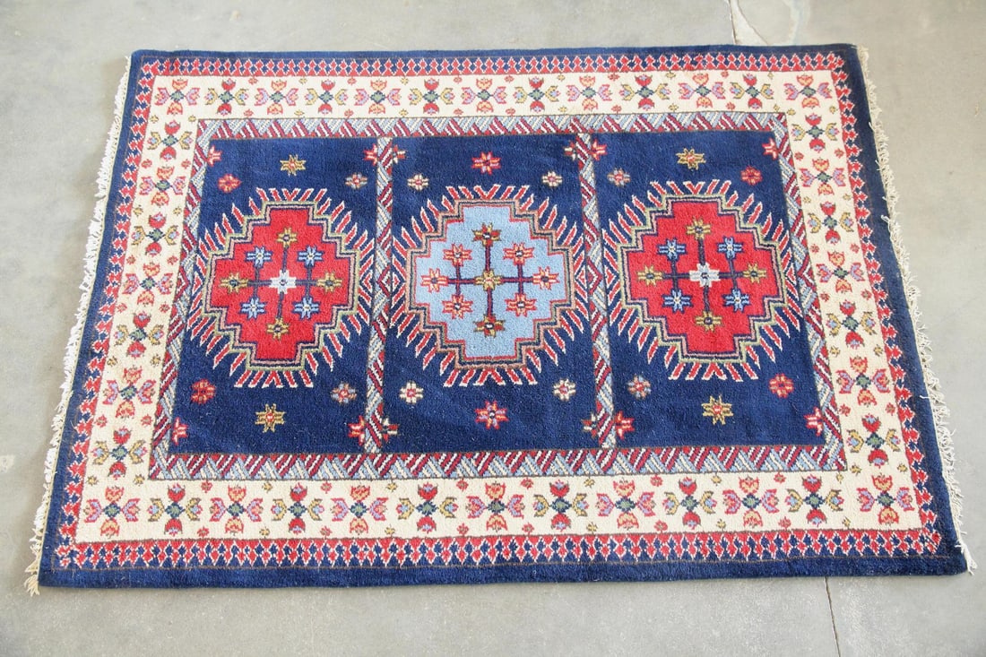 Caucasian Style Wool Rug, Triple Medallion: Caucasian Style Wool Rug, Triple Medallion. A rug with three prominent central medallions, surrounded by geometric and floral borders in blue, red, and ivory. Wool on cotton foundation Dimensions are 