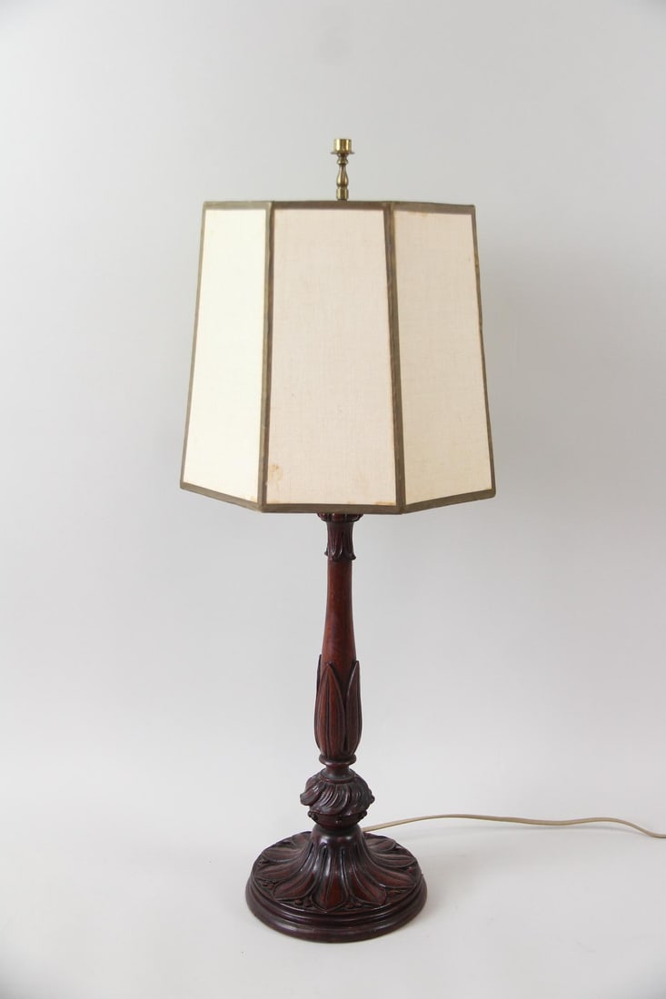 Floral Carved Mahogany Lamp: Floral Carved Mahogany Lamp. Table lamp with nicely carved base in floral motif. Includes hexagonal shade. Dimensions are 29 in h x 7.25 in w x 7.25 in d for the lamp and 10 in for the shade. Conditio