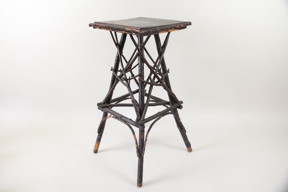 Primitive Painted Twig Side Table, Adirondack Folk Art: Primitive Black Painted Twig Side Table. This wooden pedestal table is constructed of slim tree limbs nailed together on a tripod base, with a squared top surface. It has a worn dark paint or stain. D