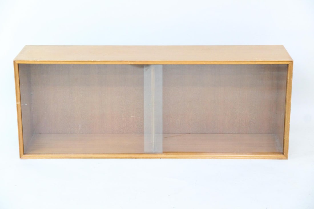 Danish Modern Floating Wall Cabinet, Wood & Glass: Danish Modern Floating Wall Cabinet, Wood & Glass. A simple floating cabinet or bookshelf made of light-toned wood, with two sliding glass doors. Dimensions are 20.5 in h x 54 in w x 13 in d.