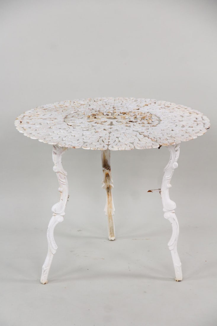 Victorian Cast Iron Garden Table: Victorian Cast Iron Outdoor Patio Garden Table. Cast iron table with 3 legs, round filigree top and white finish. Lower tier is broken. Dimensions are 26 in h x 31.5 in w x 31.5 in d. Condition is fai