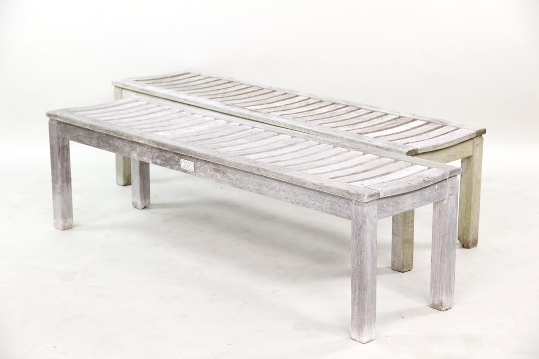 Pair of Outdoor Country Casual Teak Benches: Pair of Outdoor Country Casual Teak Benches. Pair of slatted outdoor benches made of grey weathered teak wood. Marked with a Country Casual metal label on the back. Dimensions are 17 in h x 58.5 in w 
