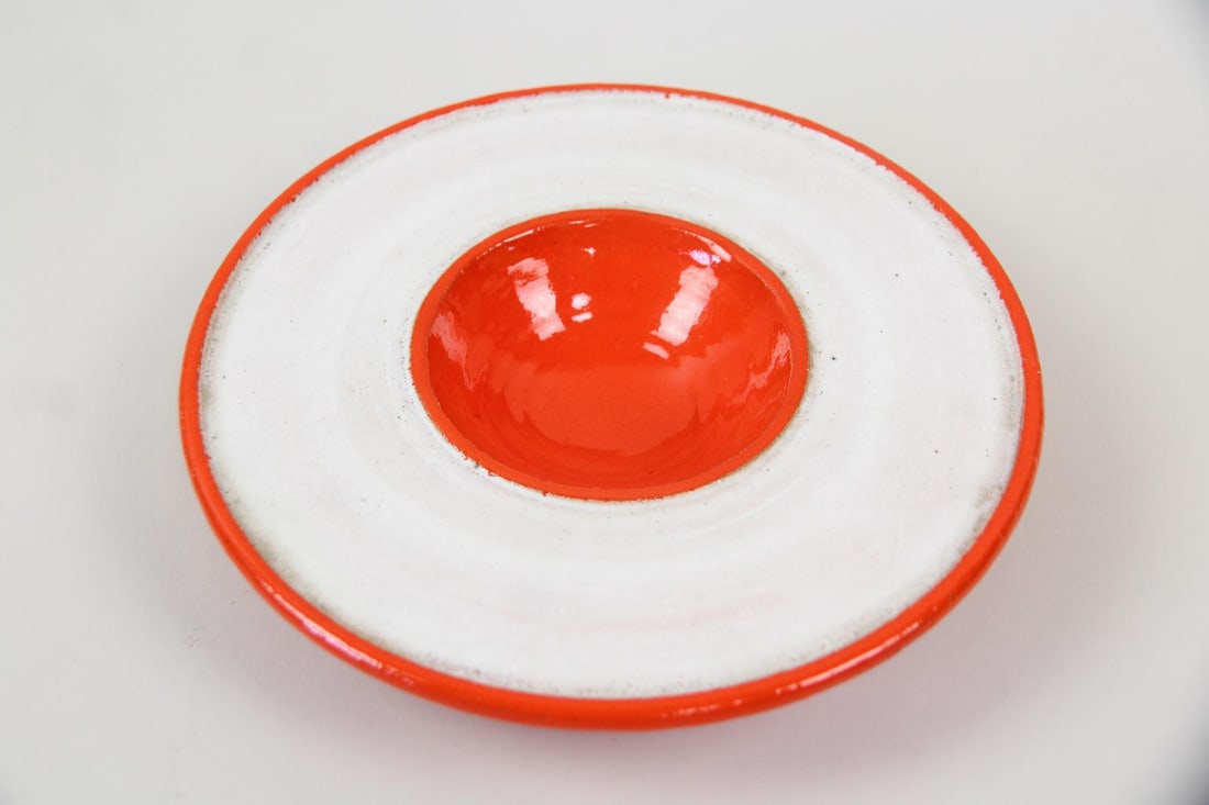 Italian Modernist Ceramic Nut Dish for Saks Fifth Ave.: Mid-Century Modern Italian Space Age Red & White Pottery Dish for Saks Fifth Ave. Striking vibrant red-orange and white dish with concave center and wide rim, marked on underside Italy and with a