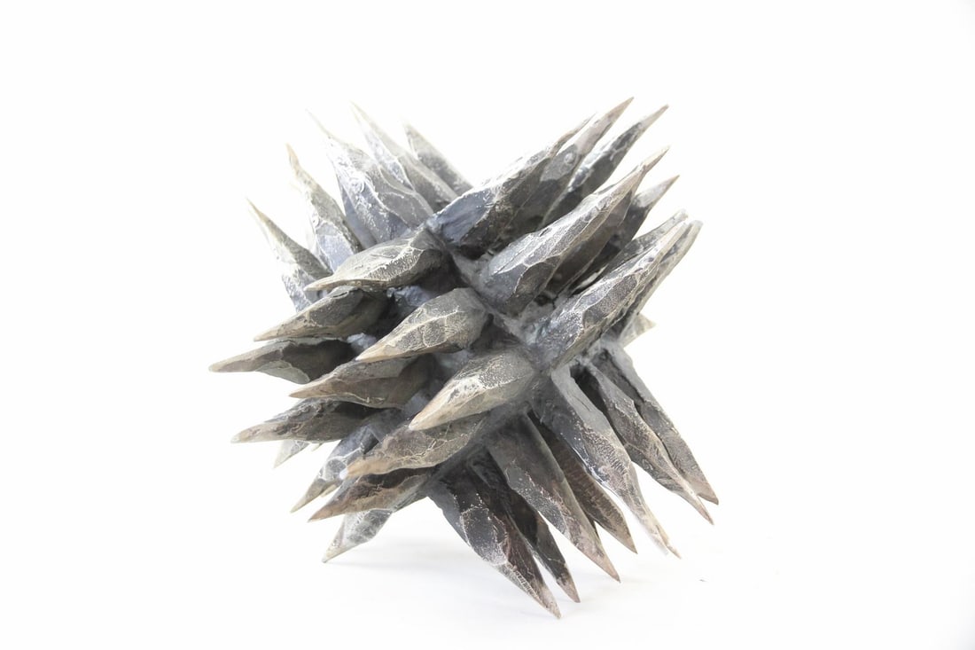 Brutalist Abstract Spiky Metal Sculpture: Abstract Spiky Metal Sculpture. Spiky metal decorative sculpture resembling a sea urchin or star-like cluster with textured, pointed spikes. Dimensions are 13 in h x 13 in w x 13 in d. Condition is