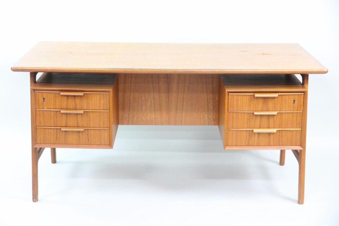 Omann Junn Sculptural Teak Executive Desk: Gunni Omann for Omann Jun Danish Modern Teak Executive Desk. This desk has warm teak wood construction with a floating tabletop design. One side with suspended three-drawer cabinets, the other with