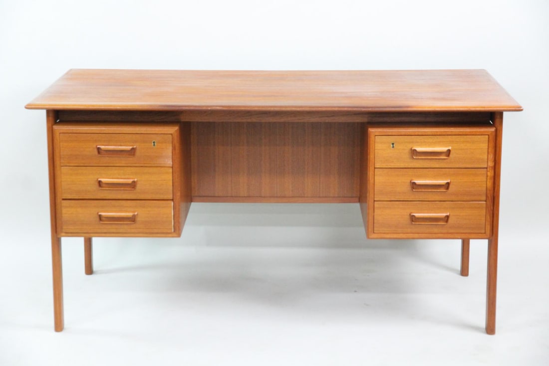 Danish Modern Teak Executive Desk, H.Sigh & Son: Danish Modern Teak Executive Desk, Willy Sigh. Writing desk made from richly grained teak, featuring a floating desktop silhouette. It has drawers to either side with sculpted solid teak handles.