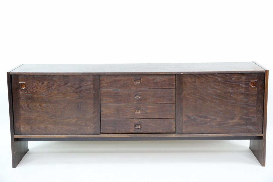 ST Mobler Wooden Credenza: Danish Modern ST Mobler Wooden Sideboard. A credenza with sliding doors and drawers and sculptural pulls. Made of wood with a dark stain. Stamped "STM, Denmark" to the back. Dimensions are 28.5 in h