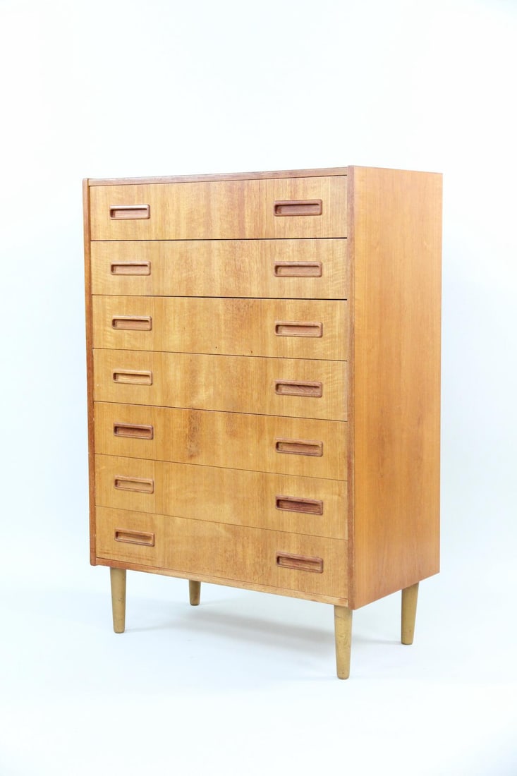 Westergaards Møbelfabrik Teak Highboy Dresser: Danish Mid-century Modern Westergaard Mobelfabrik Teak Dresser. A 7-drawer dresser made of warm teak wood, featuring tapered legs and sculptural handles. Label to the back is torn, this piece is by