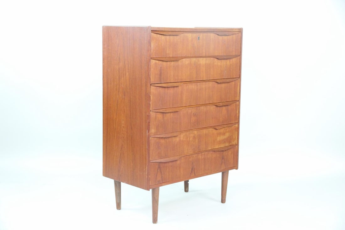 Sculptural Danish Chest of Drawers, Teak: Danish Mid-century Modern Chest of Drawers, Teak. A chest of drawers made of warm teak wood, featuring sculptural pulls and tapered legs. Dimensions are 44 in h x 30.75 in w x 16.75 in d. Condition