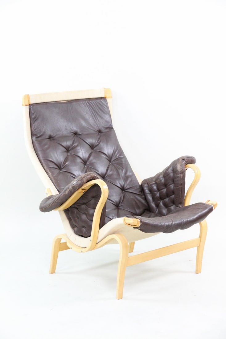 Bruno Mathsson for Dux Pernilla Lounge Chair, Brown Leather: Mid-Century Modern Bruno Mathsson for Dux Pernilla Leather Lounge Chair. Iconic lounge chair made of bent birch, plywood, and deep brown leather. Marked Bruno Mathsson by Dux. Dimensions are 37 in h