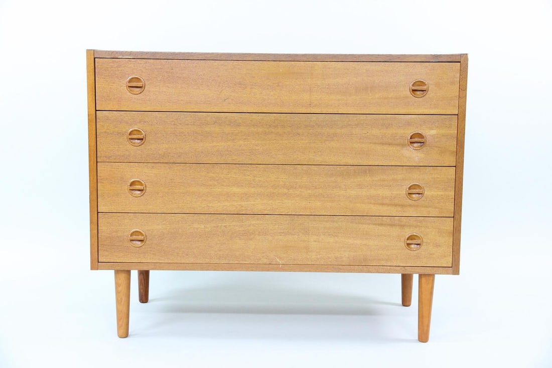 Danish Teak Dresser, Sculptural Pulls: Danish Modern Chest of Drawers, Sculptural Pulls. A timeless petite dresser made of warm teak wood with four drawers featuring circular sculptural pulls. Dimensions are 31.25 in h x 39.5 in w x 17.25