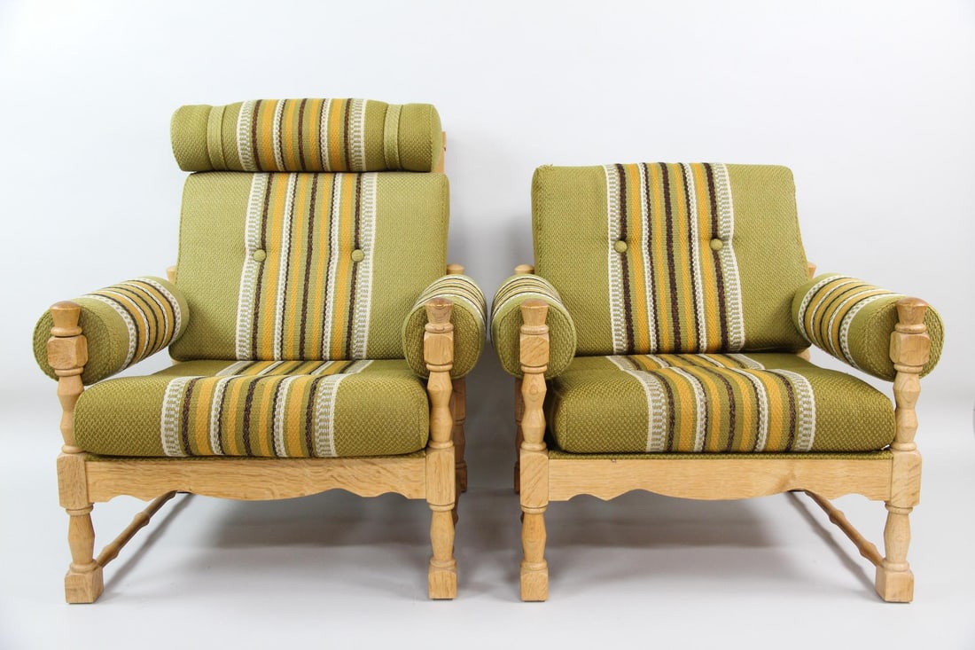 His and Hers Pair of Oak Lounge Chairs, Henning Kjaernulf: His and Hers Pair of Danish Oak Lounge Chairs, Henning Kjærnulf. Pair of comfortable chairs in 2 sizes are believed to be by Henning Kjærnulf. Featuring upholstered arms, carved frames and green, br
