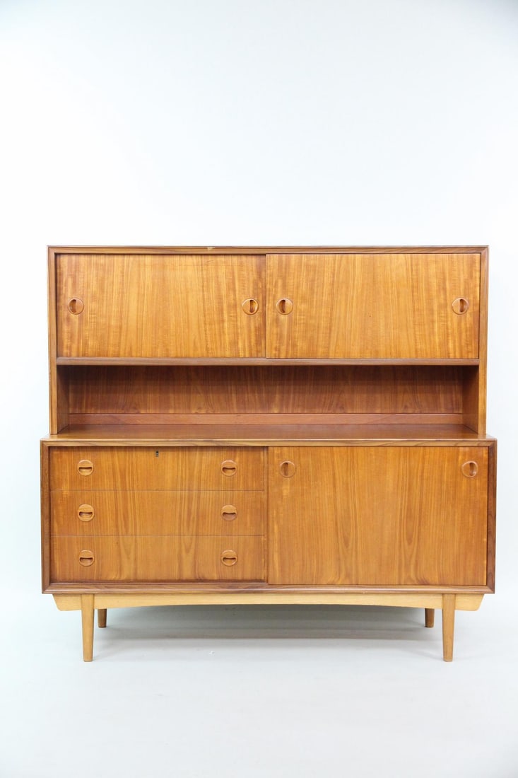Teak Stepback Hutch Cabinet: Danish Modern Teak Stepback Hutch Sideboard Cabinet. Nice cabinet comes apart into 2 pieces, with the top set back. Includes 3 storage units with sliding doors and 3 drawers. Dimensions are 55 in h x