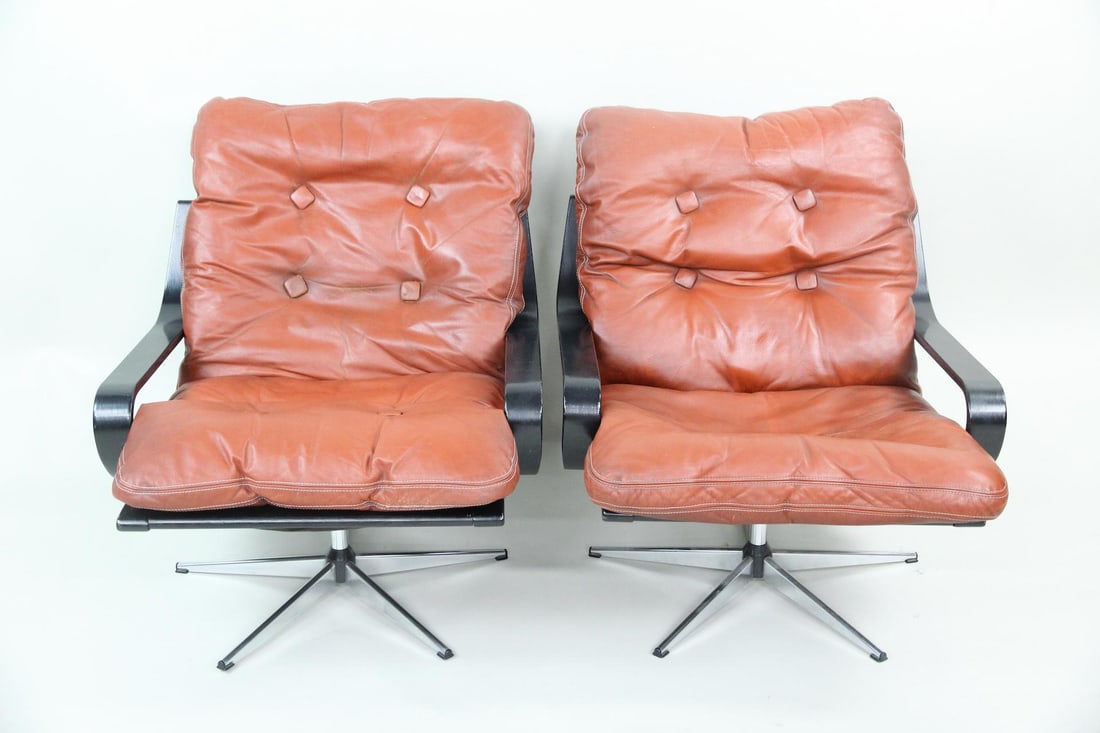 Pair of Burnt Orange Leather Swivel Lounge Chairs: Pair of Danish Modern Orange Leather Swivel Lounge Chairs. Matching chairs with button-tufted burnt orange or rust leather cushioning, black bentwood frames and five-star metal swivel bases. Dimension