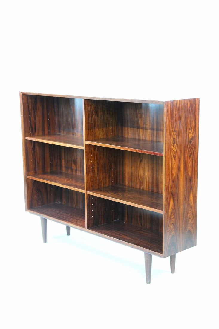 Rosewood Adjustable Bookcase, 2 of 2: Danish Mid-century Modern Rosewood Adjustable Bookshelf, 2 of 2. A minimal bookcase with open, adjustable shelving. Made of rosewood with tapered legs. Dimensions are 43.25 in h x 53.25 in w x 12 in