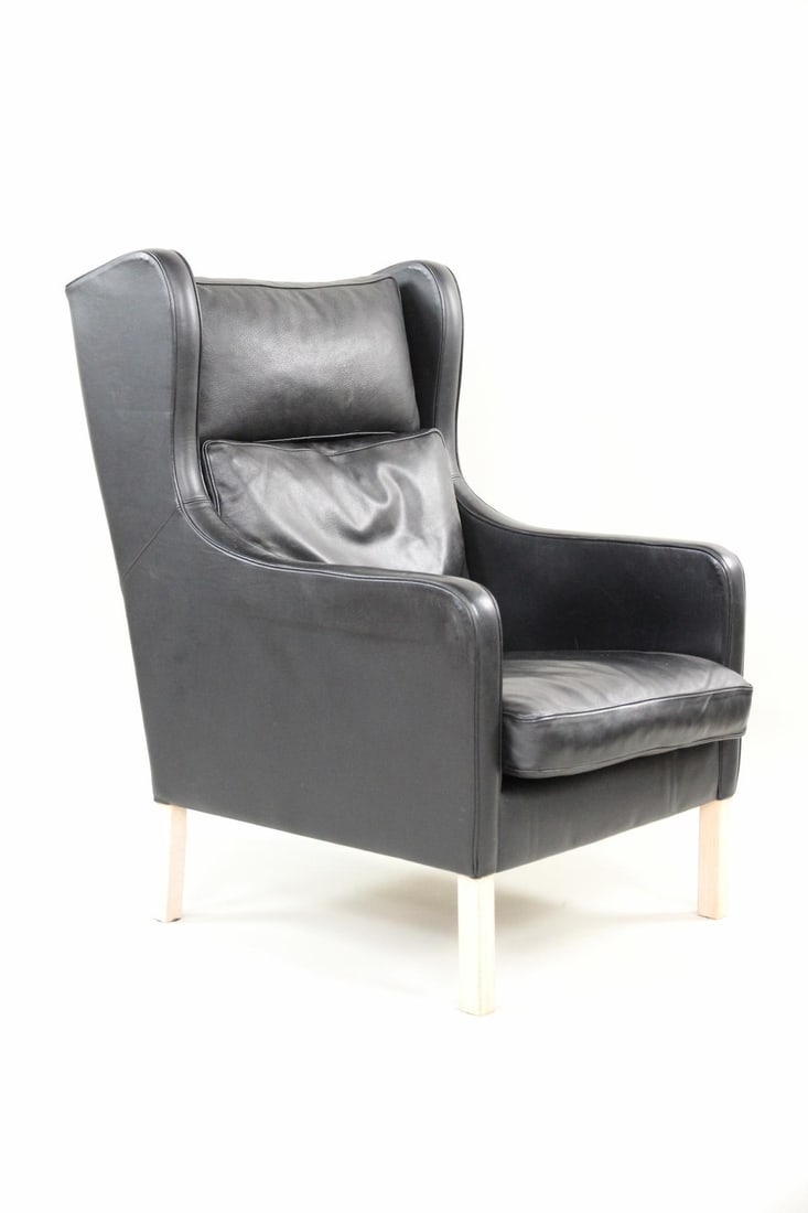 Mogens Hansen Leather Wingback Lounge Chair: Danish Mid-century Modern Mogens Hansen Leather Wingback Chair. A great high-backed lounge chair in black leather with light oak legs. Unmarked, this is by Mogens Hansen. Dimensions are 43 in h x 27.5