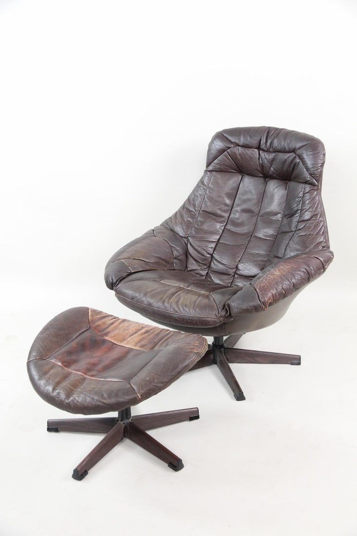 H.W. Klein Brown Leather Swivel Chair & Ottoman: Mid-century modern Danish Swivel Shair & Ottoman. In brown leather upholstery, designed by H.W. Klein. Very stylish wood-grained five-prong base. Dimensions are 36.5 in h x 34.75 in w x 38 in d. Seat 