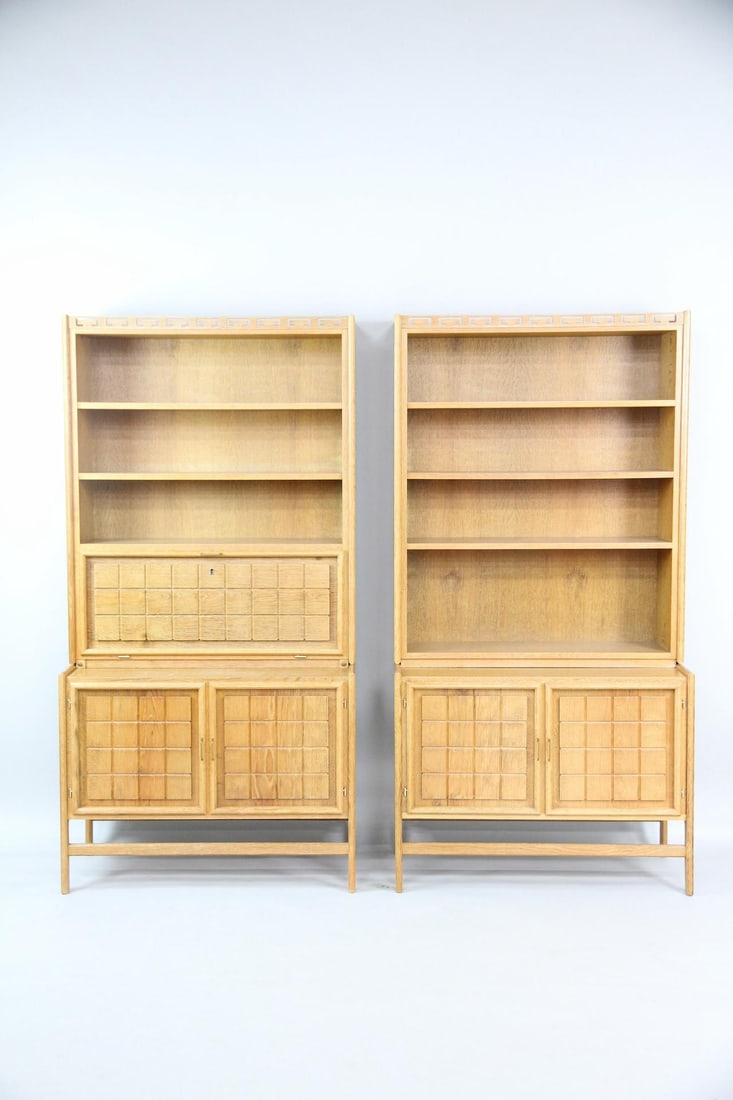 Pair of Minimalist Oak Bookshelf Cabinets: Pair of Danish Mid-century Minimalisy Book Shelf Oak Cabinets. Pair of cabinets made of light oak with open shelving sections on top. The lower cabinets have distinctive grid-patterned relief. One