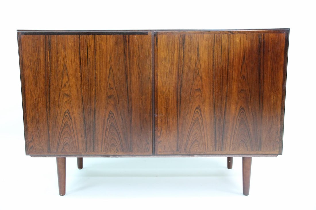 Minimalist Rosewood Sideboard Cabinet by Omann Jun "Classic": Danish Mid-Century Modern Minimalist Rosewood Sideboard Credenza Cabinet. Cabinet with 2 doors and 3 shelves inside, veneered in attractive book matched rosewood. Dimensions are 31.5 in h x 47 in w x