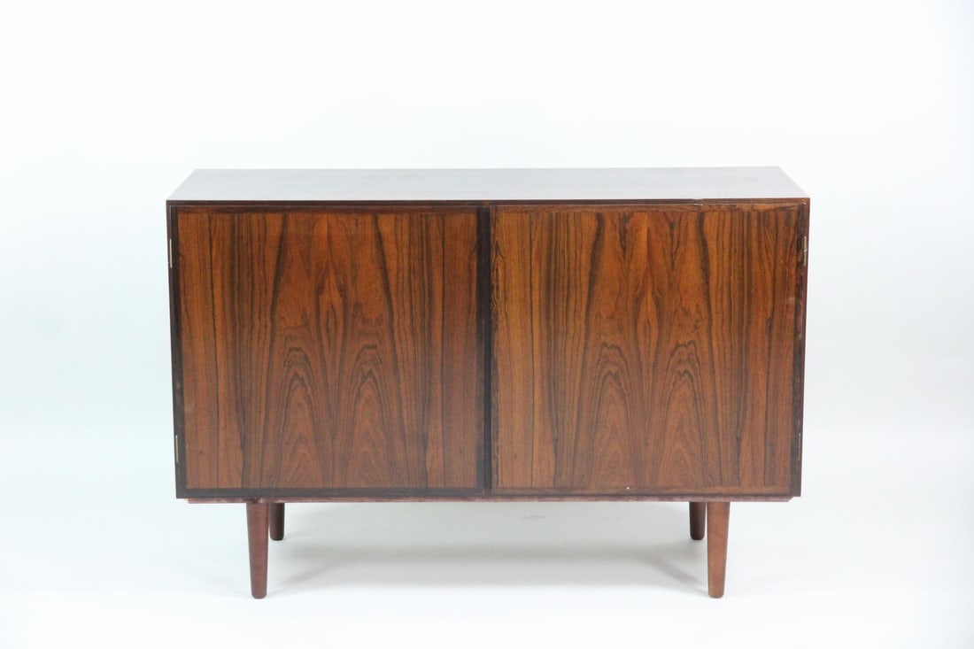 Omann Jun Rosewood Sideboard Cabinet: Danish Mid-century Modern Rosewood Sideboard Cabinet, Credenza. A petite credenza with two doors, an interior shelf and 4 drawers. Made of beautiful book matched rosewood veneer with tapered legs.