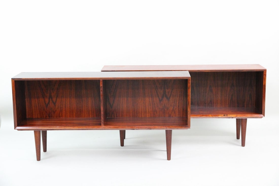 Pair of Rosewood Low Bookshelf Cabinets: Pair of Danish Modern Rosewood Lowboard Bookshelf Console Cabinets. Matching pair of open cabinets for books, media or display, made of rosewood with tapered legs and vertical dividers. Dimensions