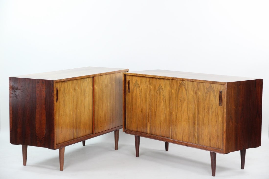Pair of Danish Modern Rosewood Cabinets: Pair of Danish Modern Rosewood Cabinets. Matching cabinets with sliding doors, interior shelves, and shallow upper drawers. Made of rosewood with beautifully bookmatched veneer. Dimensions are 30 in