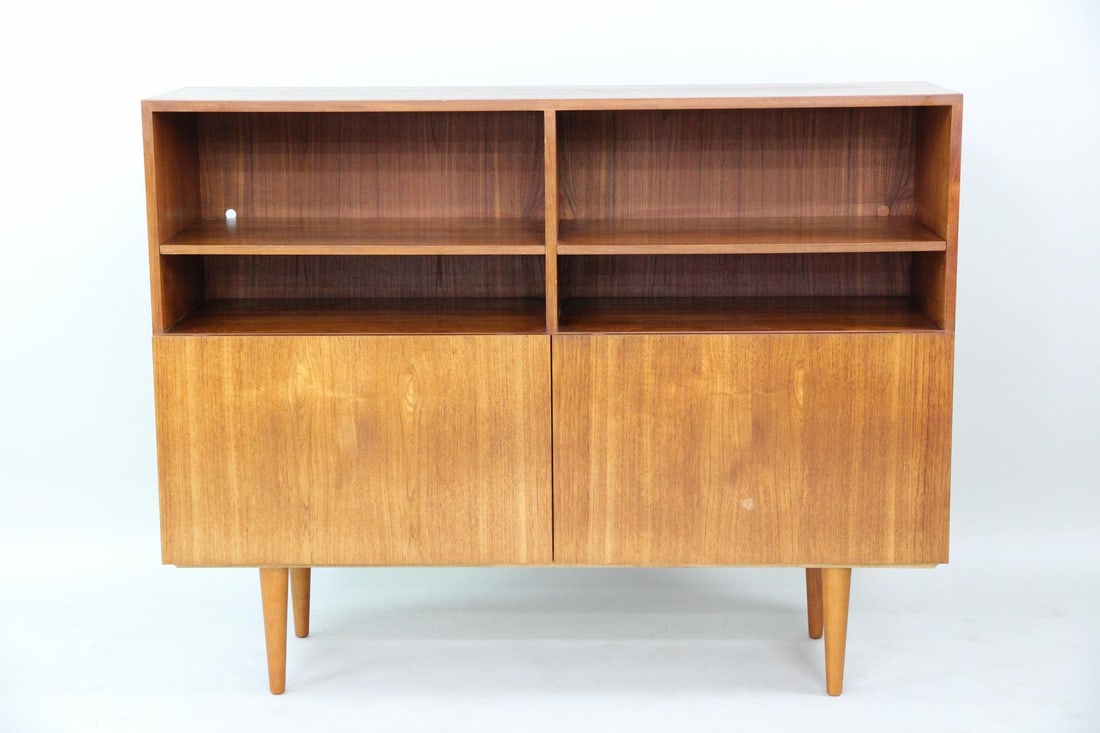Danish Teak Flip-Down Cabinet: Danish Mid-century Modern Teak Flip-Down Cabinet. A cabinet made of teak wood with flip down doors, upper shelves, and interior storage. Marked Danish Furniture Makers to the back. Dimensions are