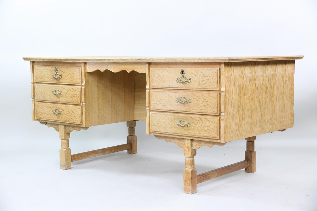 Danish Oak Executive Desk, Henning Kjaernulf: Danish Brutalist Oak Executive Desk, Henning Kjærnulf. Oak desk with ornate brass hardware, carved legs, six drawers on the front, and a bookcase on the opposite side. Dimensions are 28.5 in h x