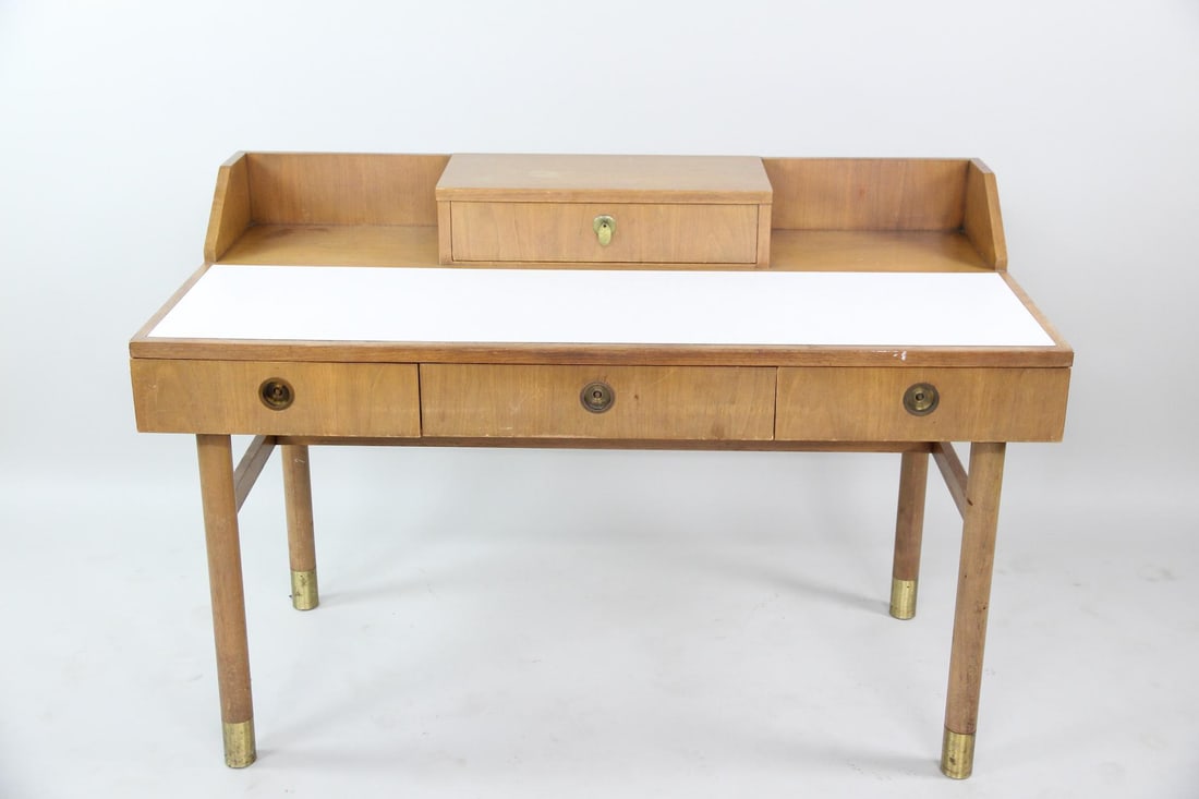 Johnson Furniture Desk with Brass Handles: Mid Century Modern Johnson Furniture Desk with Brass Handles. A petite wooden desk featuring a white laminate top and brass handles & feet. Stamped Johnson Furniture, Michigan to the drawer interior.