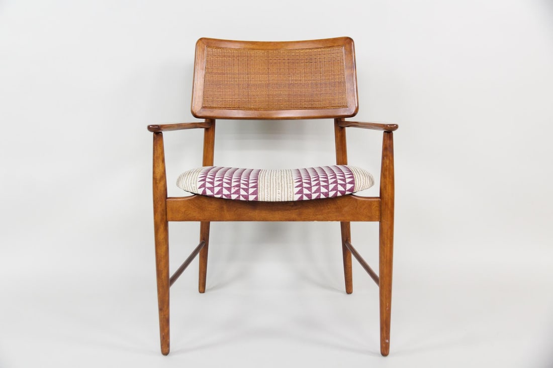 Conant Ball Caned Back Armchair: Mid-Century Modern Conant Ball Caned Back Armchair. Nice armchair with woven cane backrest and an upholstered floating seat with a geometric pattern. Dimensions are 32 in h x 24.5 in w x 20 in d. Seat