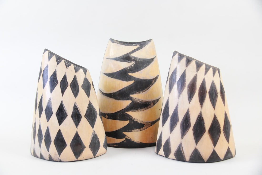 Lot of 3 Asymmetrical Black & Tan Pottery Vases, Harlequin: Lot of 3 Asymmetrical Black & Tan Pottery Vases, Harlequin. Three pottery vessels in 2 forms, with Harlequin black diamond and zigzag patterns on tan backgrounds. Dimensions are 12.25 in h x 9 in w x