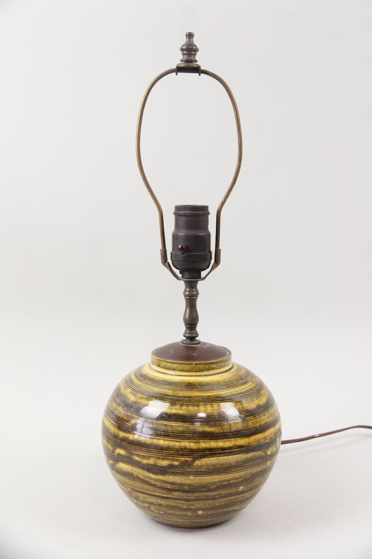 Kahler Studio Striped Pottery Lamp: Danish Mid-Century Modern Herman Kahler Studio Striped Pottery Lamp. Lamp with round pottery base in striped yellow and brown glaze. Marked on underside HAK. Dimensions are 18.25 in h x 7 in w x 7 in 