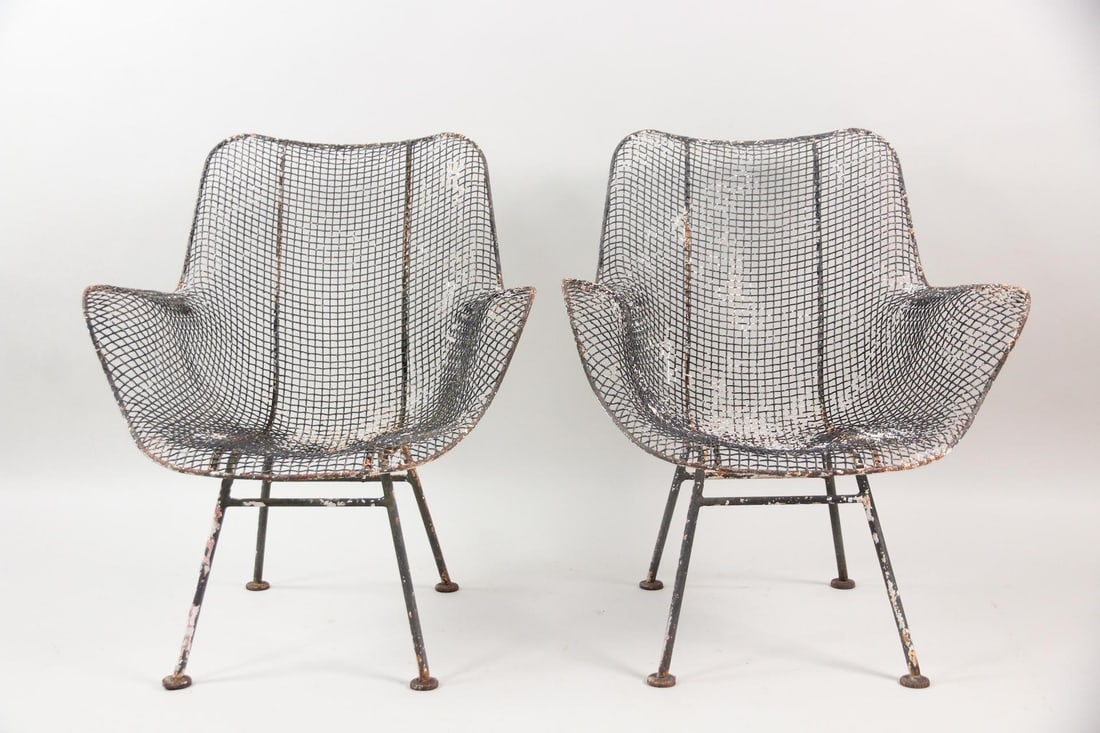 Pair of Russell Woodard Black Sculptura Arm Chairs: Pair of Mid-Century Modern Russell Woodard Sculptura Metal Chairs. These mesh metal armchairs for outdoor garden or patio have molded seats on iron legs. No maker's mark, they are Sculptura chairs by