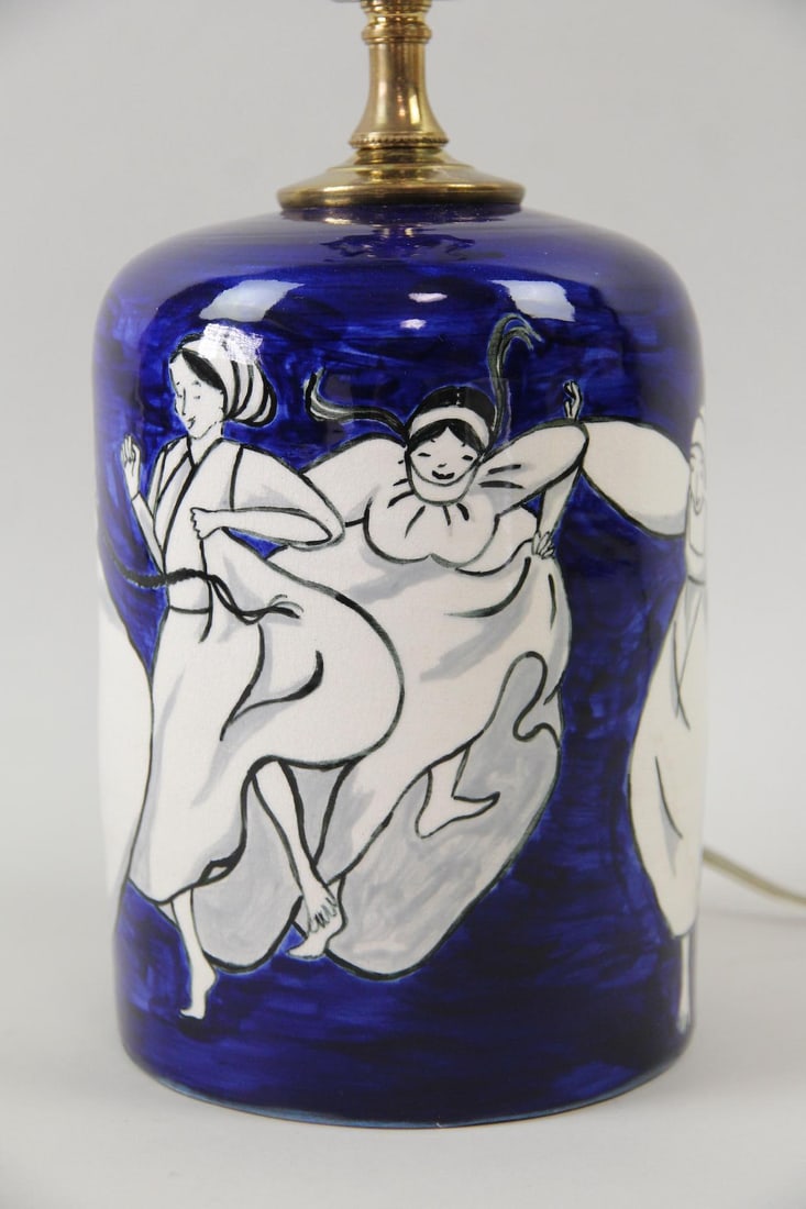 Cobalt Blue Ceramic Lamp with Dancing Women Motif: Cobalt Blue Ceramic Lamp with Dancing Women Motif. Ceramic table lamp in deep cobalt blue, decorated with dancing women figures in white. Signed E on underside. Dimensions are 17.5 in h x 5.25 in w x 