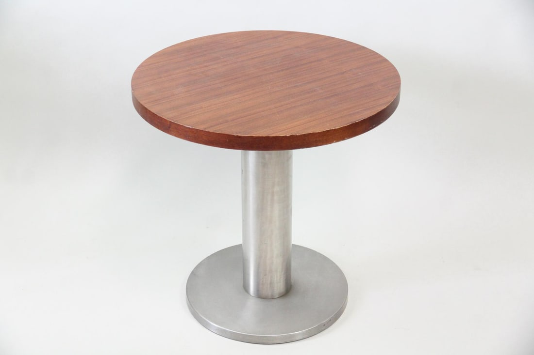 Italian Wood & Metal Pedestal Side Table: Italian Wood & Metal Pedestal End Table. A table with a wood veneer top and metal pedestal base, likely aluminum. With a sticker to the underside, "Made in Italy." Dimensions are 22 in h x 22 in w x
