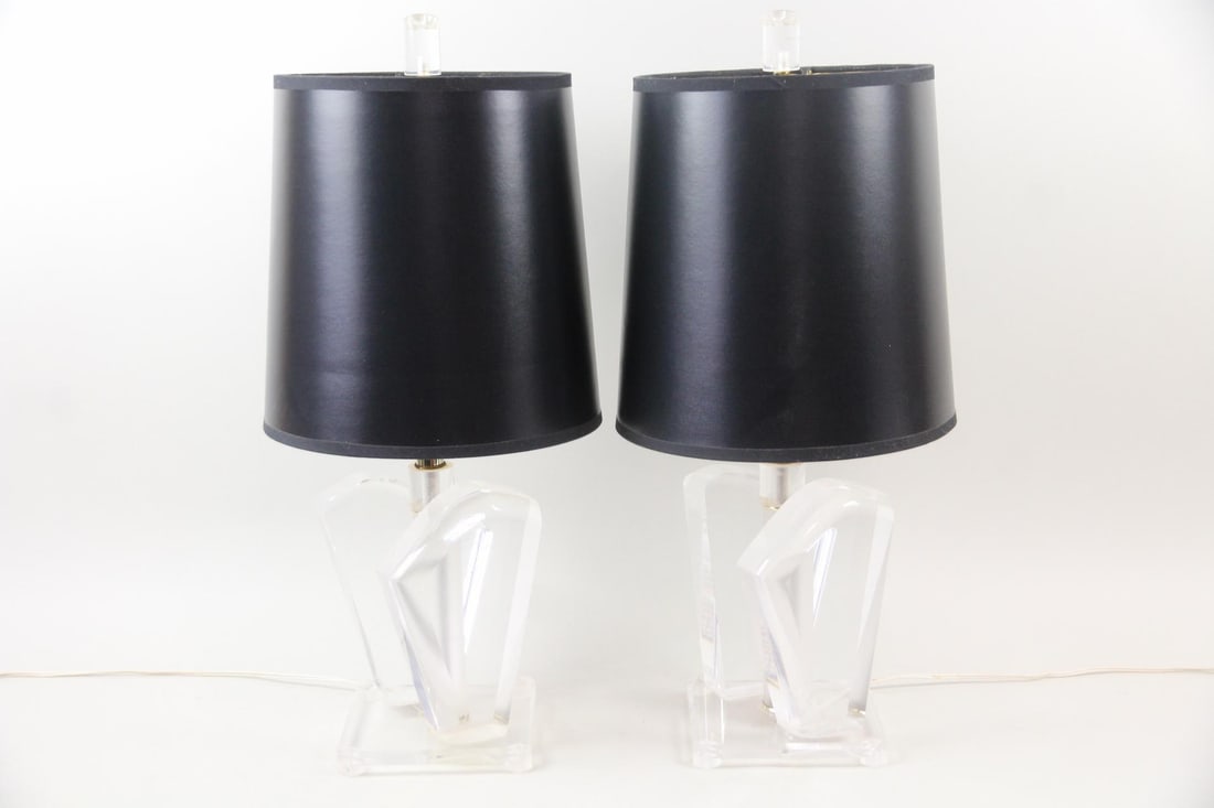 Pair of Sculptural Lucite Table Lamps: Pair of Mid-century Modern Sculptural Lucite Table Lamps. Matching lamps with sculptural, geometric bases made of clear lucite and black drum shades. Dimensions are 26 in h x 7.5 in w x 7.5 in d.