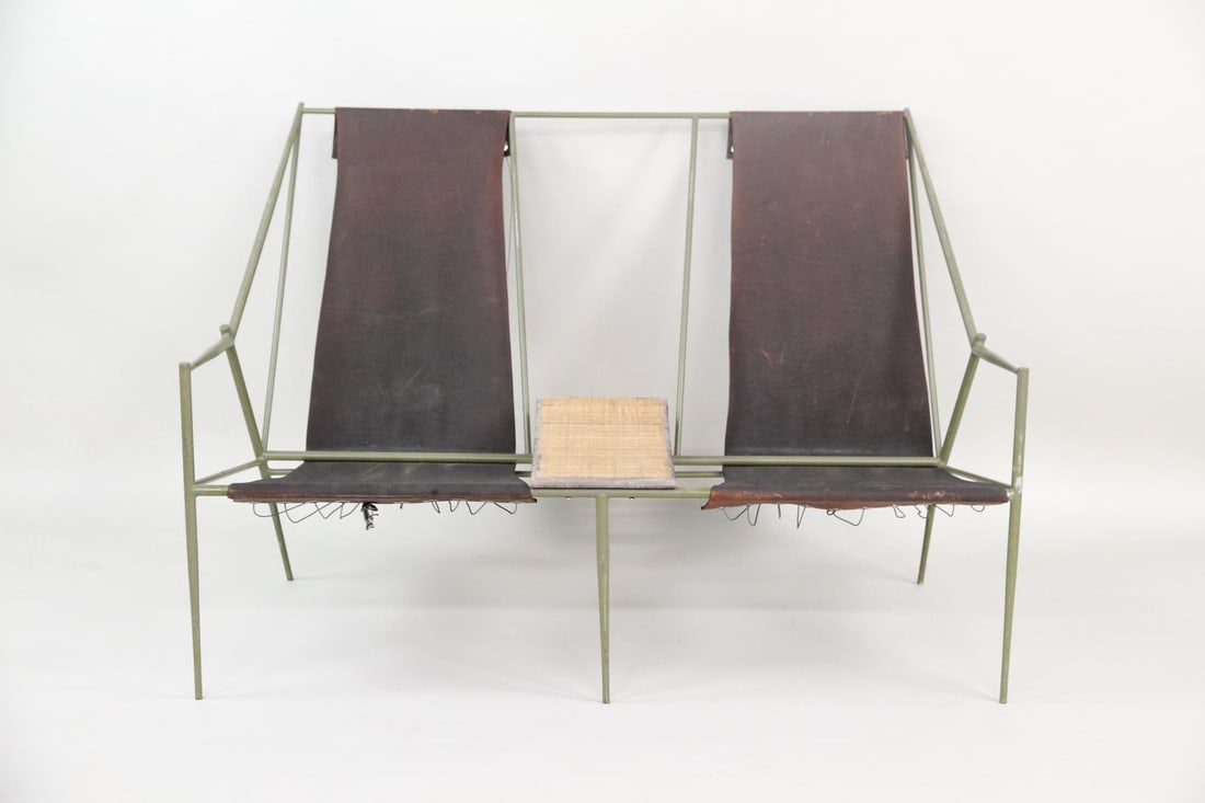 Modernist Metal & Leather Sling Two-Seater Lounge Chair: Modernist Metal & Leather Two-Seater Chair, style of Jacques Adnet. Beautiful two-seater featuring an elegant metal frame painted moss green, with leather sling chairs and integrated wooden table. Dim