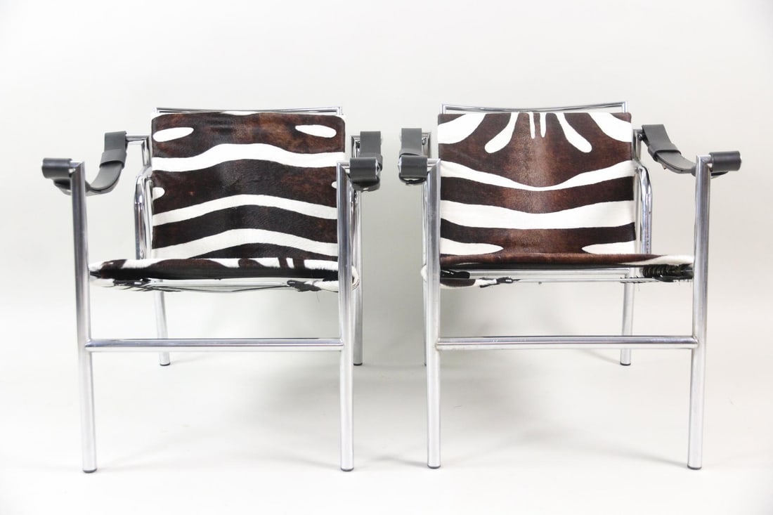 Pair of Le Corbusier Zebra Print LC1 Chairs: Pair of Le Corbusier Zebra Print LC1 Chairs. Matching pair of LC1 Basculant chairs designed by Le Corbusier, Pierre Jeanneret, and Charlotte Perriand, with iconic zebra print animal hide upholstery an