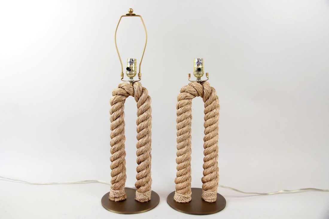 Pair of Nautical Rope Table Lamps: Pair of Contemporary Nautical Rope Table Lamps. Pair of lamps featuring a distinctive U-shaped design, crafted from natural rope. Dimensions are 25.25 in h x 7.75 in w x 7.75 in d with harp, 19.5 in